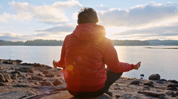 istock Meditating in nature at sunset. Getting away from it all. 1360059546