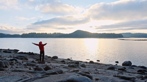istock Man relaxing in nature at sunset. Getting away from it all. 1360059547