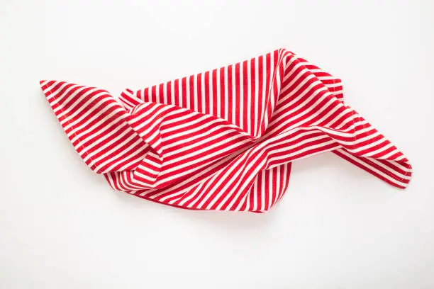 Photo of Top view of striped napkin on the white background. Close-up.