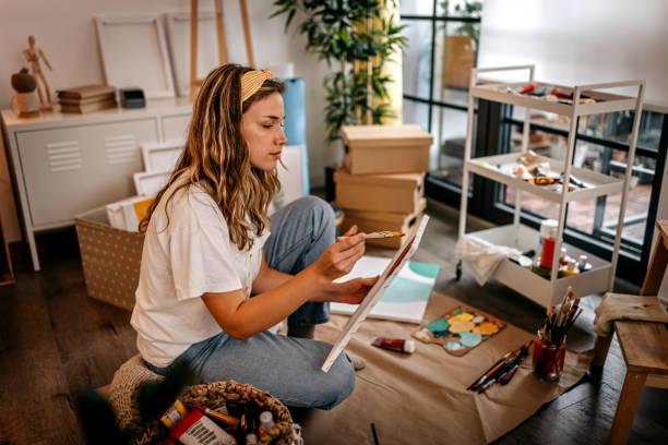 istock Female artist painting on canvas 1360061822
