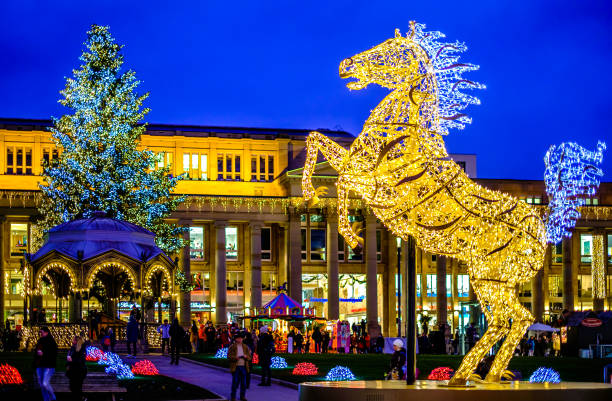 Stuttgart, Germany - December 17: Visitors at the annual exhibition of illuminated symbols at the Christmas market in the old town of Stuttgart on December 17, 2021