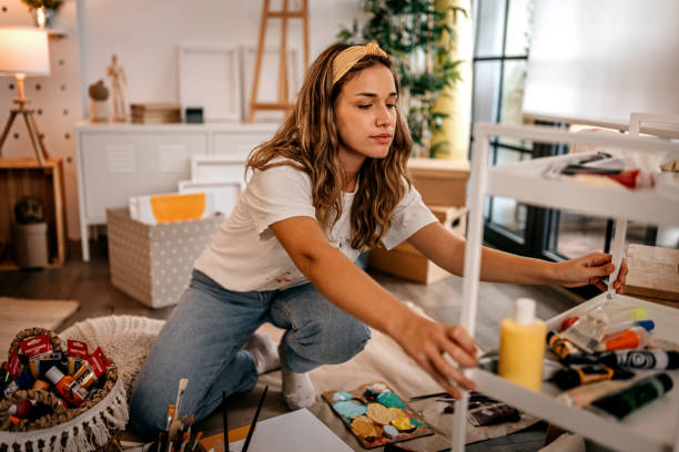 istock Artist taking paint tube while painting in studio 1360061904