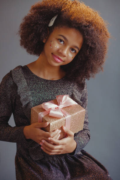 istock Lovely festive girl open a gift box 1360061978