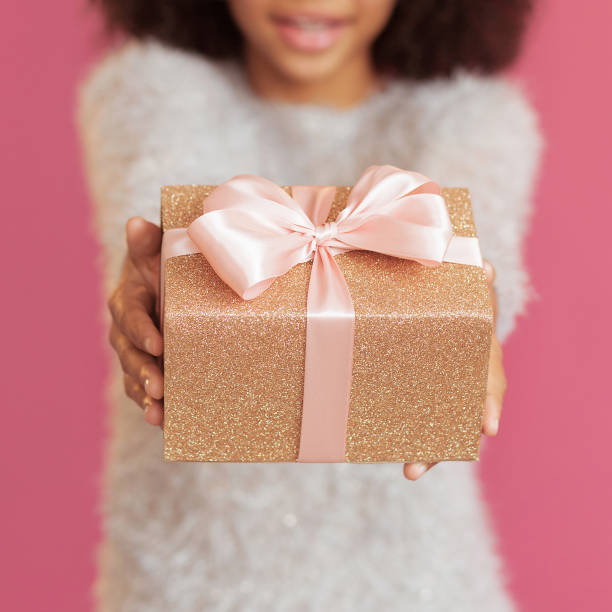 istock Cute beautiful girl giving a gift box 1360061984
