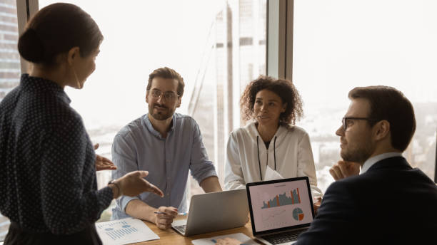 istock Indian coach make presentation for diverse clients at meeting 1360062835