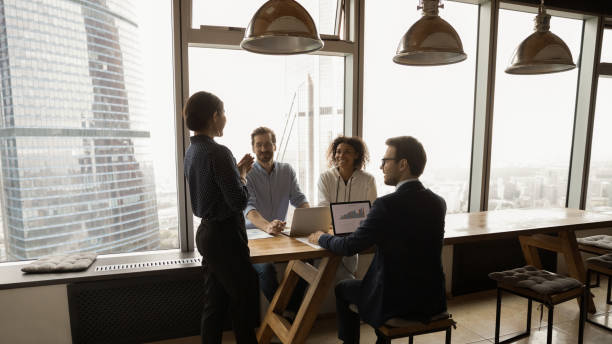 istock Multiracial colleagues with Indian ethnicity leader gather in briefing 1360062836