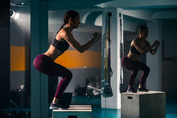istock A young female doing a box jump in the gym 1360063412