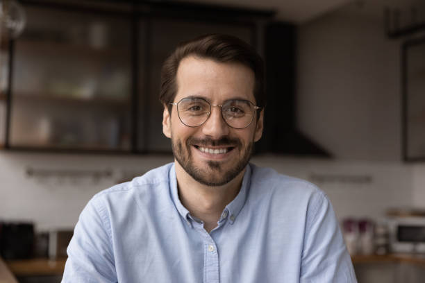 istock Headshot profile picture young businessman sit in kitchen webcam view 1360063450