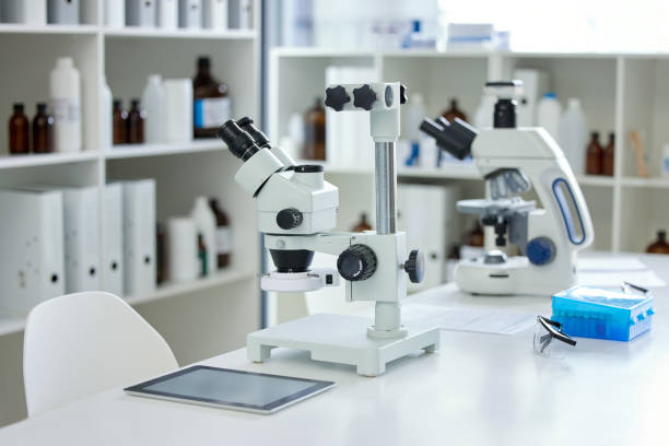 istock Shot of a microscope and digital tablet on a table in an empty lab 1360064173