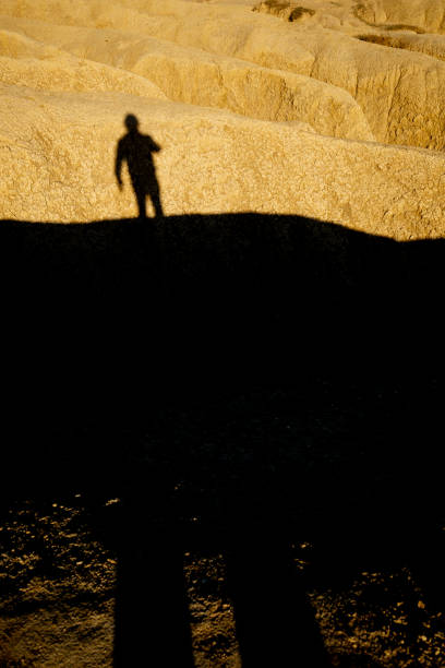 shadow of man on rocky ground