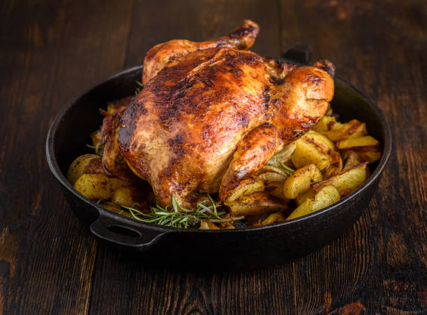 istock Roasted chicken with potatoes and onions 1360064420