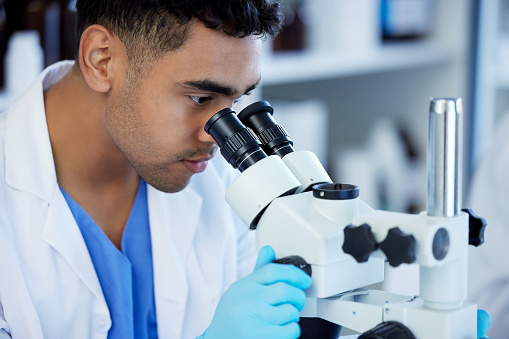 Microscope Man Shot Of A Young Man Using A Microscope In A Lab Stock Photo - Download ...