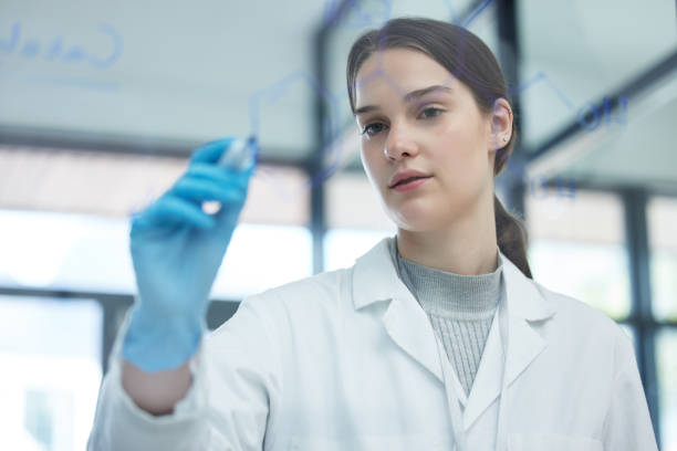 istock Shot of a scientist solving equations on a glass screen in a laboratory 1360065276