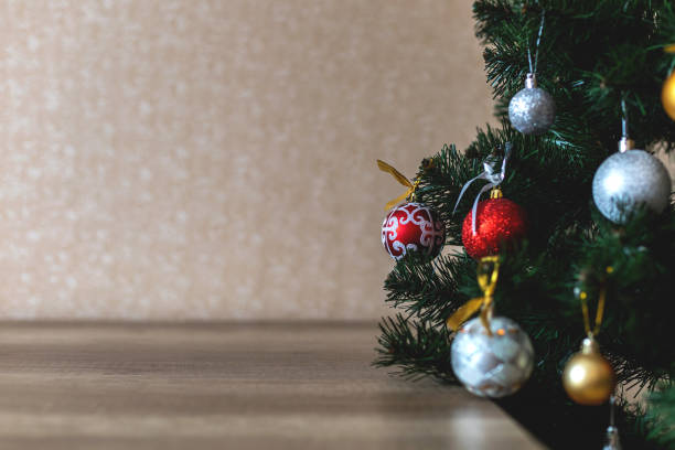 istock Decorated christmas tree with wooden table and blurred background 1360065287