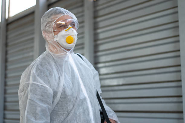 istock Worker wearing protective suit disinfection gear disinfect surface public place 1360065956