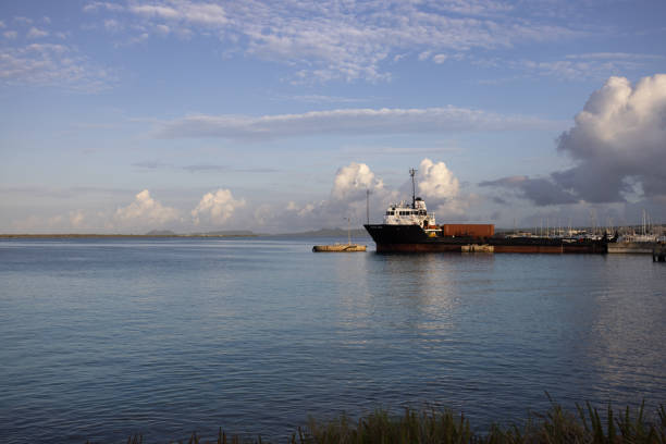 istock Morning seascape with a cargo ship near pier. 1360066780