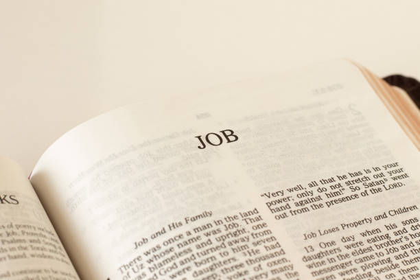 istock Open Holy Bible Job Book Old Testament Scripture on white background 1360067423
