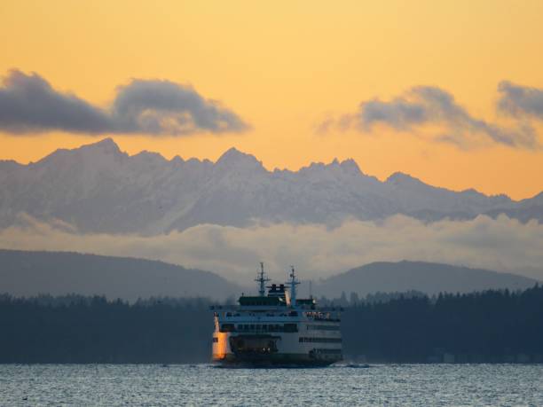 istock Ferry and the Olympic Mountains at Dusk 1360067440