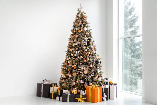 istock Christmas tree in white interior with stylish black and orange gift box 1360067635