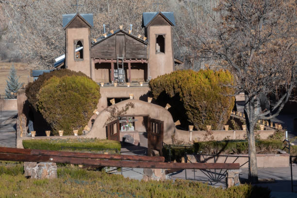 Old church adobe building bell towers (El Santuario de Chimayo at Chimayo, New Mexico) near Santa Fe, New Mexico in southwestern United States of America.