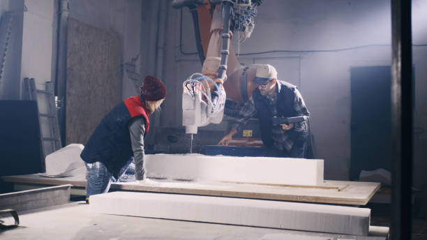 istock Craftsman discussing polymer block with colleague 1360081523