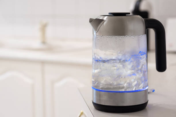 istock Boiling electric kettle on the kitchen table close-up 1360082262