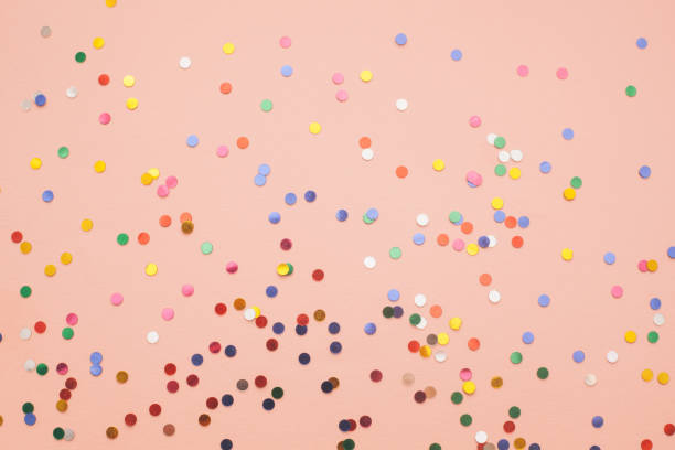 istock Colorful small round confetti abstract pink festive background 1360082475