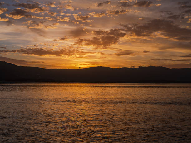 istock Golden sunset with dramatic sky clouds over Knysna lagoon 1360085032