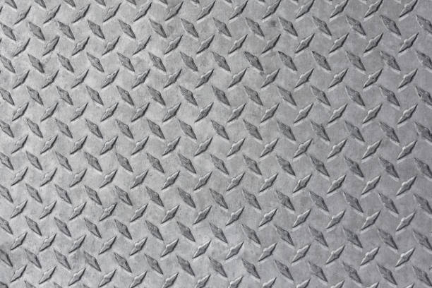 Steel Diamond Plate Background photo of a shiny steel diamond plate. diamond plate stock pictures, royalty-free photos & images