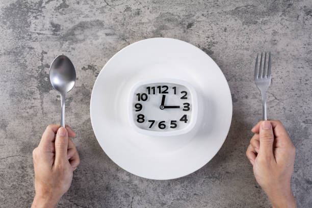 istock Eat meal time healthy eating concept hand hold spoon and fork 1360092984