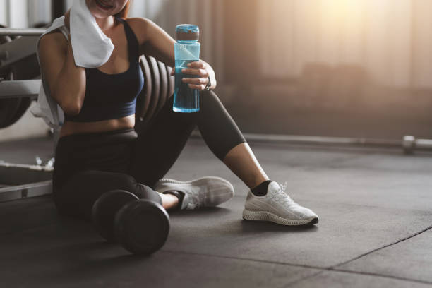Woman exercising in the gym fitness sitting relaxation after exercise. Woman exercising in the gym fitness sitting relaxation after exercise. aerobics photos stock pictures, royalty-free photos & images