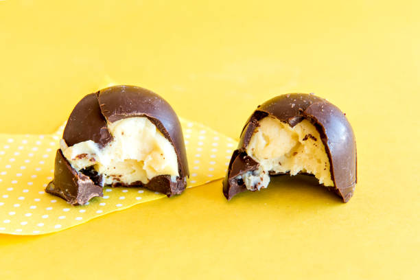 istock Chocolate truffle stuffed on yellow background. 1360107746