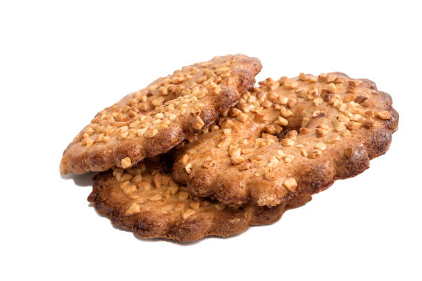 istock Shortcrust pastry biscuits with peanut peanut topping in a ring on an isolated white background. 1360110148