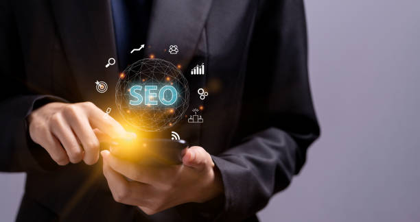istock SEO Search Engine Optimization, Hand holding mobile phone and concept for the best promoting ranking traffic on website, optimizing your website to rank in search engines or SEO. 1360110276