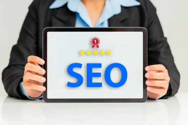 SEO Search Engine Optimization, Hand holding tablet and concept for the best  promoting ranking traffic on website, optimizing your website to rank in search engines or SEO.