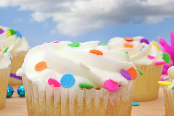istock Cupcakes with white icing and Colorful Sprinkles 1360112787