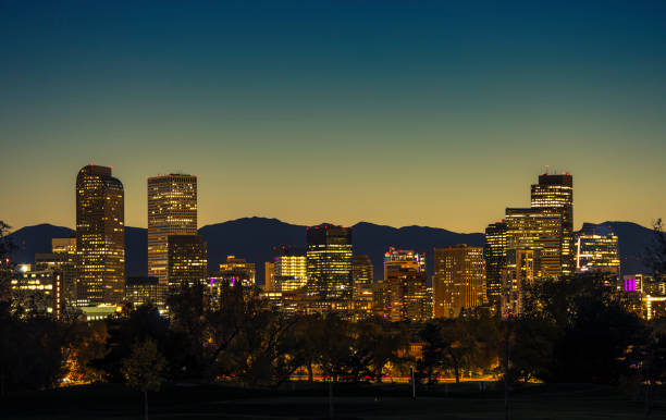 istock Illuminated Denver Downtown Towers and Front Range Mountains in a Background 1360114413