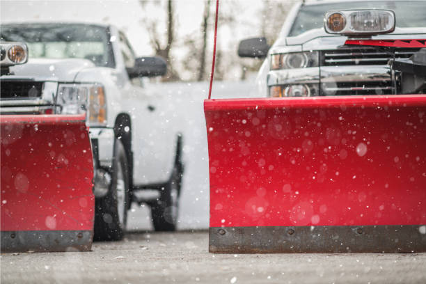 Winter Weather Ready Snow Plow Pickup Trucks Adjustable Commercial Grade Plow Blades Installed on a Pickup Trucks. Vehicles Ready For a First Snow Fall. Falling Snow. snow plow stock pictures, royalty-free photos & images