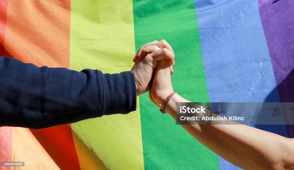 Couple holding hands LGBTQIA Rights, Couple - Relationship, LGBTQIA People, LGBTQIA Pride Event, Gay Pride Parade LGBTQIA Rights Stock Photo