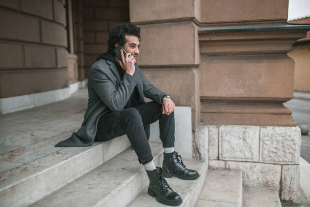 istock A smiling young man makes a phone call with his friend 1360117467