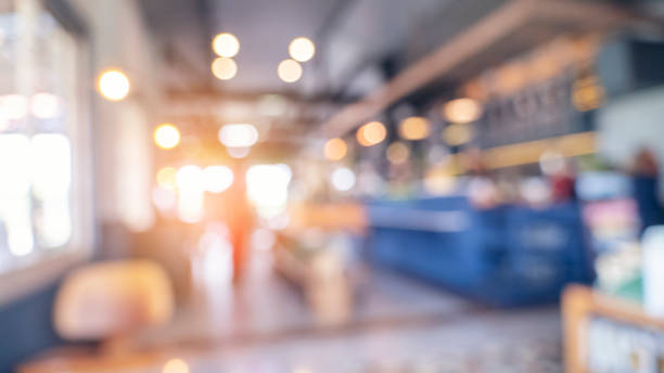 blurred background shopping mall light bokeh business event in retail store. blurry abstract background of store grocery. blur convention hall center audience present display goods products on shelf. - entrance hall fotos imagens e fotografias de stock