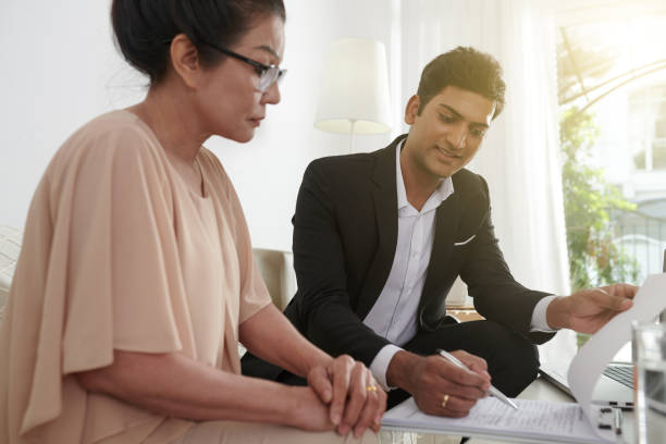 istock Agent Showing Where to Sign Insurance Document 1360123744