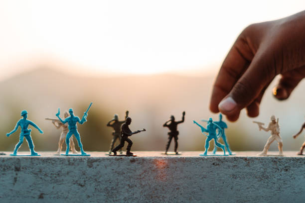 Closeup shot of hand of a kid playing with toy soldiers in front of the sun during the sunset Closeup shot of hand of a kid playing with toy soldiers in front of the sun during the sunset toy soldier stock pictures, royalty-free photos & images