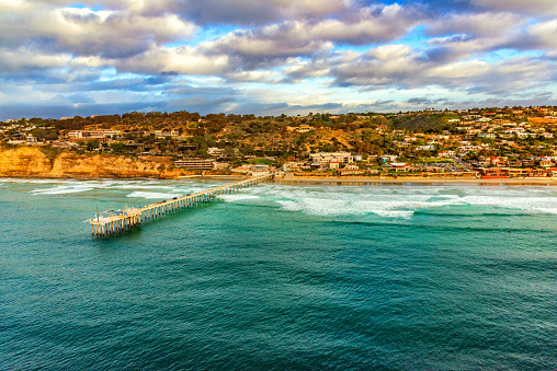 Scripps Pier of the Scripps Institute of Oceanography located on the coast of the La Jolla neighborhood in the city of San Diego, California shot from an altitude of about 800 feet over the Pacific Ocean.