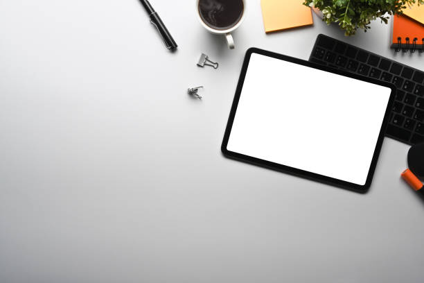 istock Top view creative workspace with digital tablet, coffee cup and supplies. 1360125147