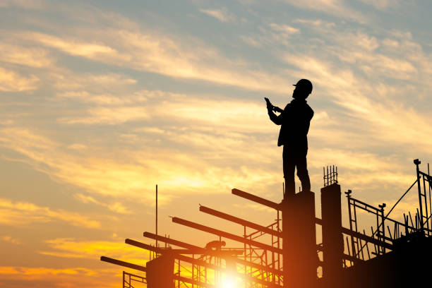 istock Silhouette of Engineer man with clipping path on building site, construction site at sunset in evening time 1360126037