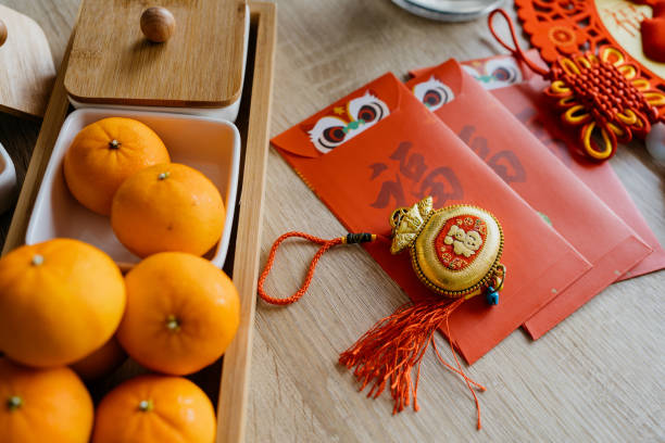 istock Chinese New Year decoration and red envelopes on table 1360126054