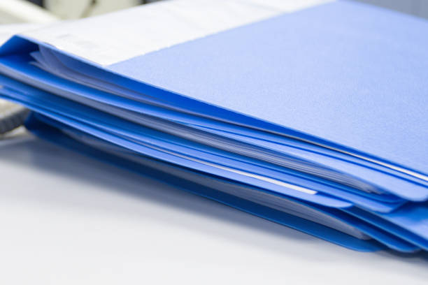 istock file folder and Stack of business report paper file on the table 1360127700