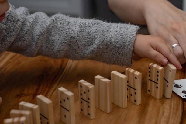 istock child's hands playing dominoes with blurred focus 1360130291