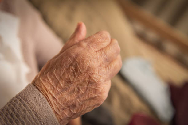 istock Parkinson's disease. An elderly woman's hand 1360130295